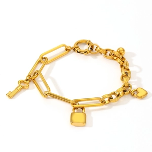 Gold stainless steel chain bracelet with key, lock, and heart charms on white background