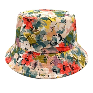 Close-up of floral bucket hat with dense stitching detail and artistic summer print