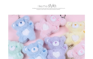 Detailed close-up of colorful plush bear keychains with heart patches on pastel background