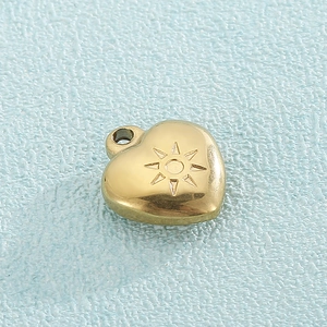 Golden heart-shaped titanium steel pendant with engraved sunburst pattern on blue surface