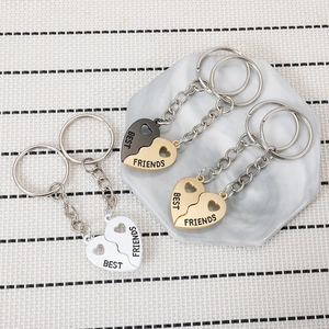 Detailed view of magnetic heart-shaped best friends keychains in gold silver and black