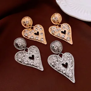 Elegant oversized heart drop earrings with shimmering rhinestones in gold and silver finish