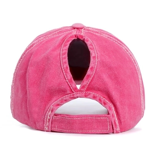 Detail of rose red washed cotton ponytail baseball cap featuring back opening and velcro strap