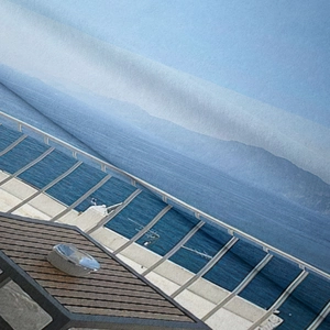 Detailed close-up of bohemian tapestry fabric showing modern architecture ocean print
