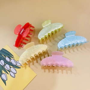 Set of five large acrylic hair claws in assorted marble colors for elegant styling