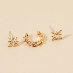 Detailed view of gold-plated star studs and crystal-encrusted ear cuff jewelry set
