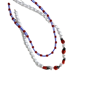 Colorful beaded necklace with pearls and ladybug pendant in vibrant retro style