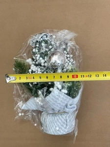 Detailed view of a 12cm mini Christmas tree with silver base and measuring tape scale