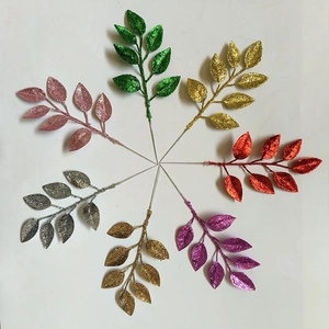 Close-up of glittered Christmas leaves in multiple colors for DIY festive wreath decor