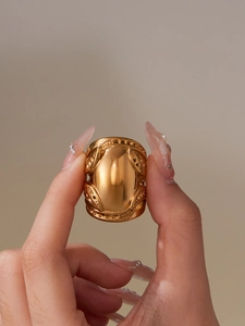 Detailed view of wide 18k gold plated stainless steel ring with vintage engraved patterns