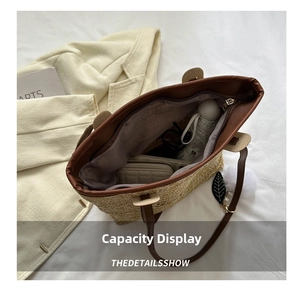 Internal view showing large capacity of woven straw tote bag with leather trim detail