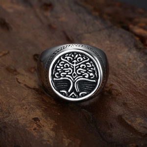 Macro view of vintage stainless steel ring featuring embossed Tree of Life pattern
