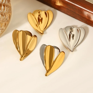 Detailed view of luxury flower-shaped heart earrings in gold, silver, and dual-tone metal