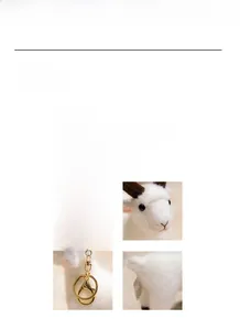 Detail view of white plush goat keychain showing soft texture and gold metal clasp