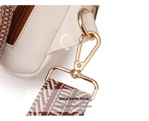 Macro detail of white PU leather bag with golden detachable hook and woven strap