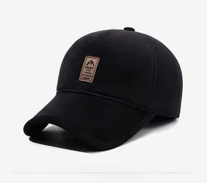 Detailed view of black baseball cap with mountain logo leather patch and warm knit texture