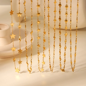 Detailed close-up of gold stainless steel necklaces with star, heart, and cross pendants