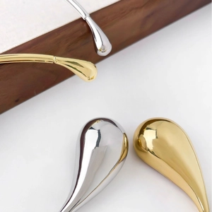 Polished gold and silver teardrop choker necklaces in a minimalist metallic fashion style