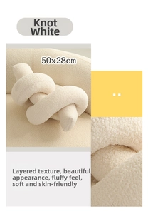 Detail view of a 50x28cm white knotted lamb wool decorative pillow with granular texture