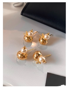 Détails des boucles d'oreilles gourde dorées avec perles blanches et zircons scintillants