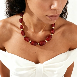 Retro necklace with chunky irregular red faceted beads and gold cylindrical metal accents