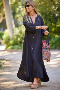 Close-up of black linen long-sleeve dress with V-neck and front buttons in natural light
