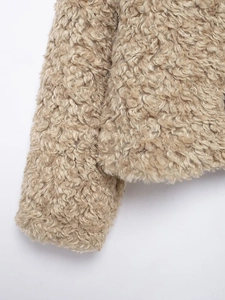 Detailed close-up showing the soft curly texture of the beige fleece jacket sleeve