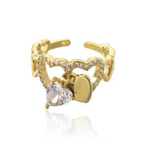 Close-up of golden heart ring with sparkling zircons and delicate pearl detailing