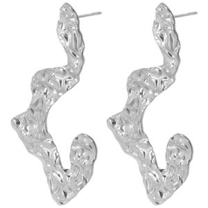 Macro shot of silver 304 stainless steel earrings with irregular hammered texture