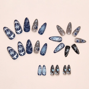 Detail of dark blue and black starry night press-on nails with 3D floral and moon art