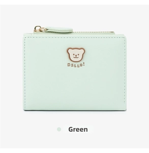 Close-up of mint green short wallet featuring a cute bear print and metal zipper closure