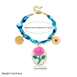 Blue and pink tie-dye bracelet with rose, sun and portrait gold plated pendants