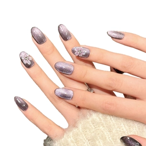 Elegant purple glitter cat-eye press-on nails with 3D floral accents and rhinestones