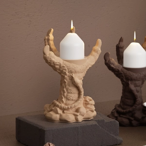 Gothic 3D dragon claw candle holder with detailed scales and pillar candle centerpiece
