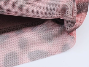 Macro detail of breathable pink mesh fabric with black leopard print and brown lining layer