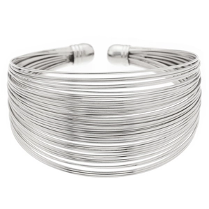 Macro view of wide layered silver wire cuff bracelet with high-polish metallic finish