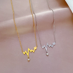 Minimalist heartbeat necklace in gold and silver finish with heart pendant and crystal