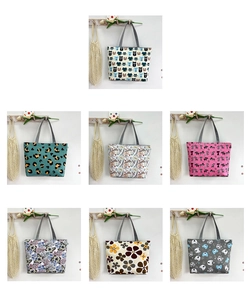 Detail of seven printed canvas tote bags featuring cat, leopard, and floral patterns