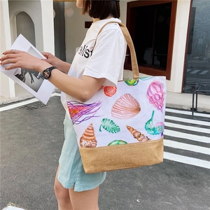 Women canvas tote bag with watercolor sea life pattern and jute bottom on model