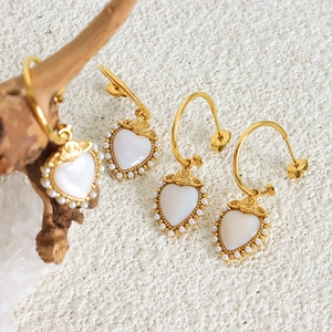 Elegant gold titanium heart earrings with mother of pearl inlay and pearl trim detail