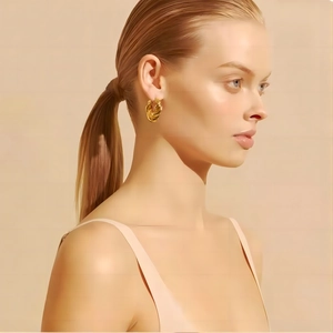Chic 18K gold plated twisted hoop earrings with elegant spiral texture on female model