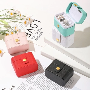 Mini travel jewelry organizer boxes in pink, black, and white with snap closure