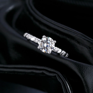 Classic 1-carat moissanite ring in 925 silver with side stones on a black leather background