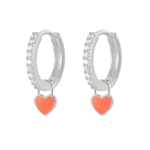 Macro detail of silver-tone hoop earrings with white zircons and coral heart pendants