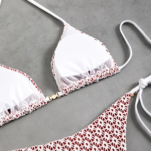 Detail of red leopard bikini with gold metal ring buckles and pleated edges