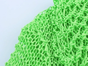 Detailed close-up showing the intricate bright green openwork knit pattern and mesh texture