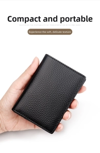 Close-up of portable black lychee texture leather card holder being held in one hand