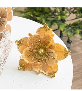 Macro detail of champagne gold velvet Christmas flower with sparkling gold glitter edges