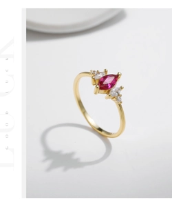 Macro view of gold S925 silver ring featuring marquise-cut ruby pink zircon and accents