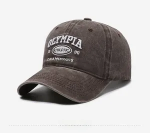 Side view of washed canvas baseball cap featuring white 1990 Olympia athletic embroidery